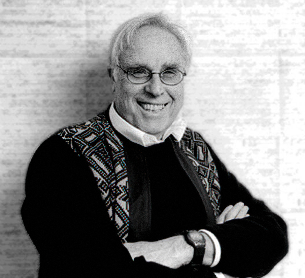 Dr. George Martin smiling and looking at the camera.
